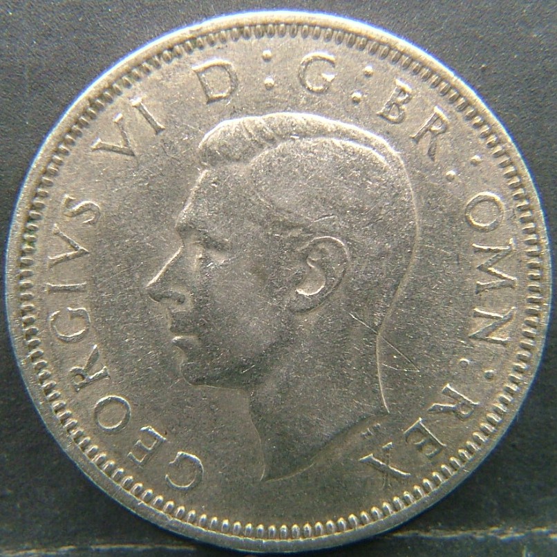 Back side of 🇬🇧 United Kingdom – Monarchs and Milestones 1 Shilling Scot 1949 coin